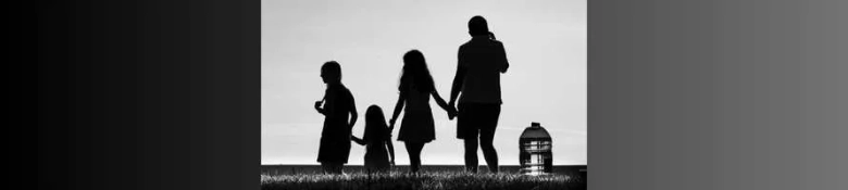 The shadows of a family group in a black and white photo