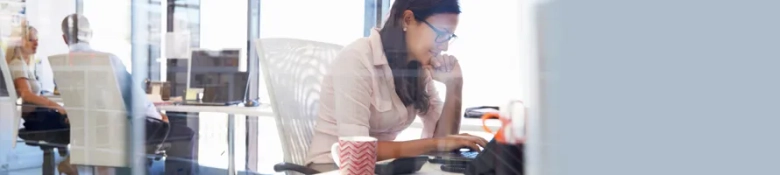 An intern at work, sitting at a computer desk