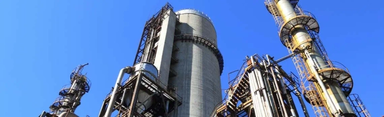 Oil refinery against blue sky: petroleum engineer job description