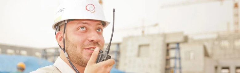 Surveyor on site talking into walkie-talkie