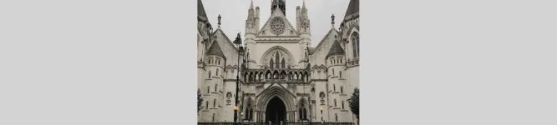 The Royal Courts of Justice against a grey background