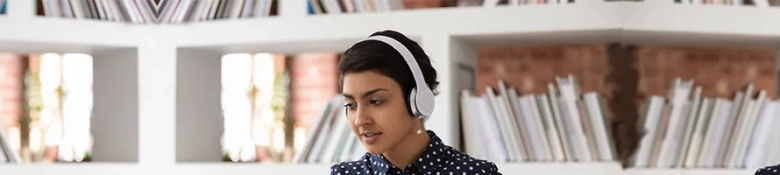 Woman wearing headphones applying for a job online.