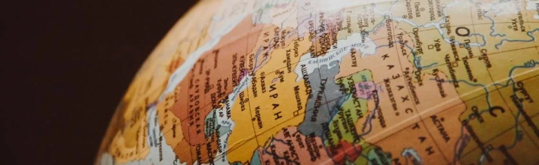 Close-up of a globe focusing on the Eurasian continent, symbolizing global travel and geography.