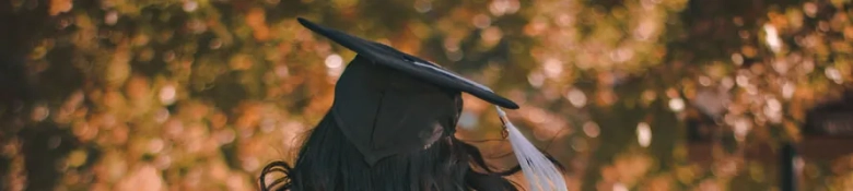 Graduate walking away from camera at graduation ceremony