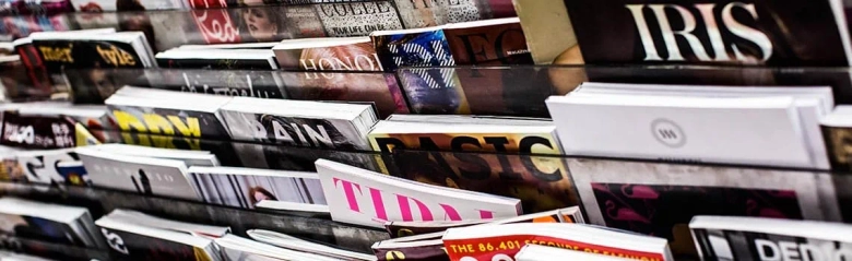 Assorted magazines displayed on a rack with visible titles.