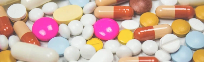A pile of different coloured pills.