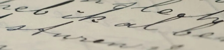 stylised, old-fashioned handwriting written on an off-white piece of paper 