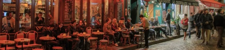 Street scene of people in French cafés along a pavement