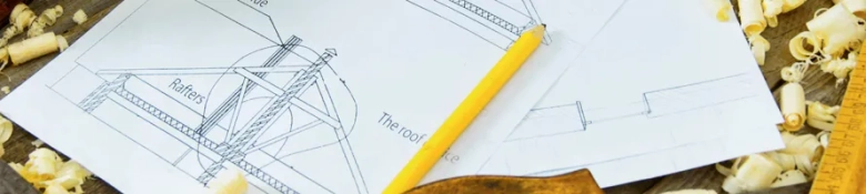 Technical drawings created by engineers and a yellow pencil