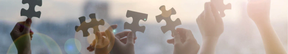 Hands holding pieces of a puzzle