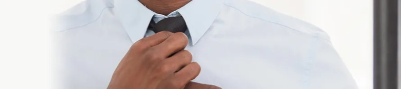 An interview candidate adjusting a tie