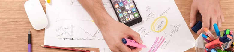 Highlighting handwritten notes next to a smartphone: careers with a marketing degree