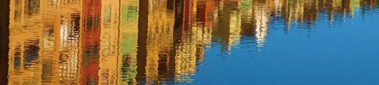 A reflection of buildings on the surface of a lake in Spain.