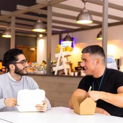 two men eating lunch 