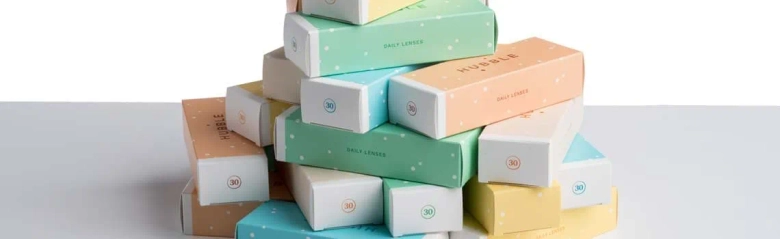 Stack of colorful product boxes with different labels indicating a variety of packaging designs.