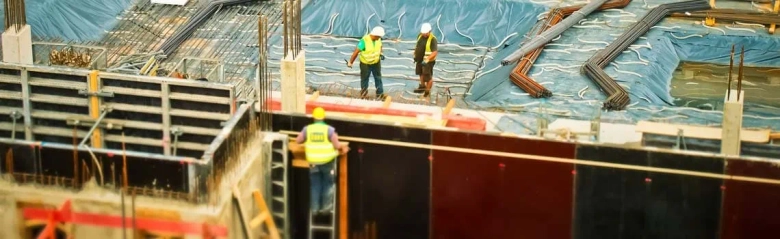 Construction managers at work on a building site.