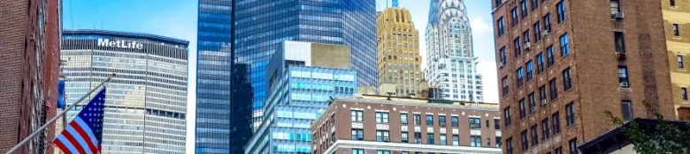 a New York street view of skyscraper buildings including the Chrysler Building.