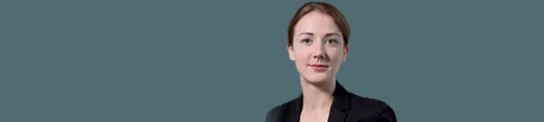 Professional headshot of barrister Amy Rogers against a teal background.