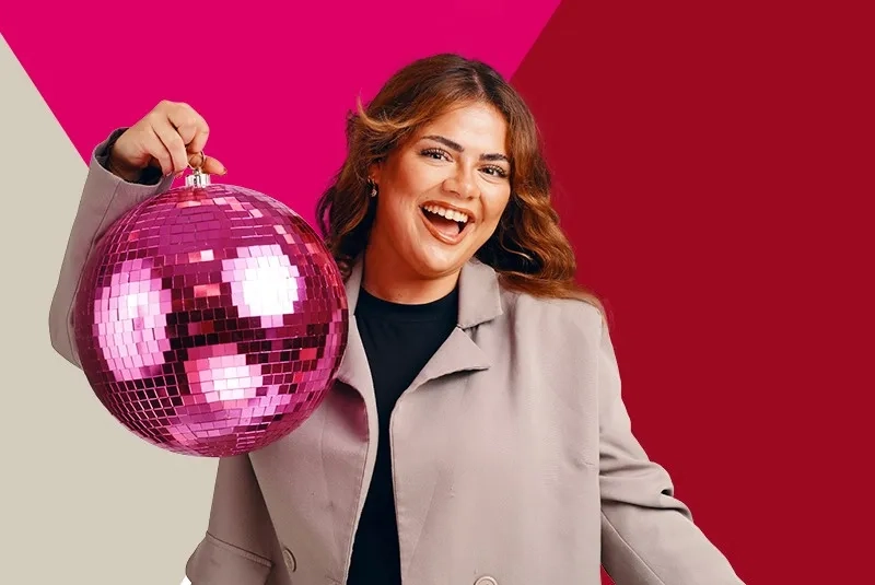 Female employee holding a disco ball