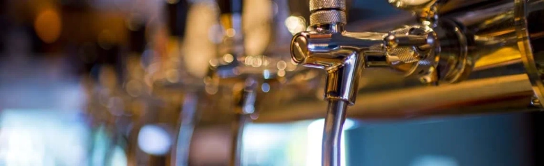 Close-up of beer taps with selective focus in a pub.