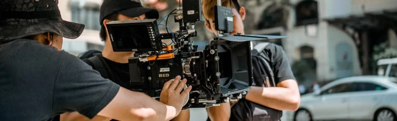 A camera operator crew working with a large camera. 