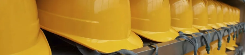Construction worker helmets in a row, to represent the construction industry