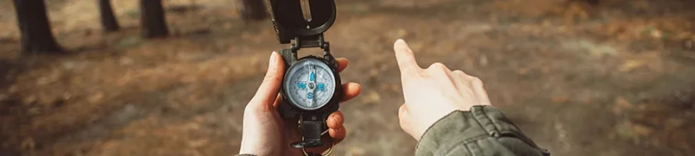 Person follows a compass along a path while pointing