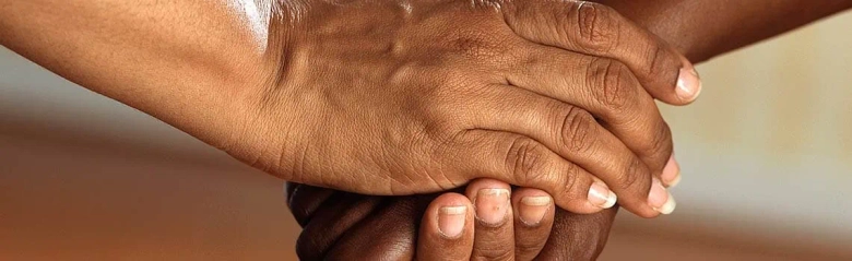 A close up of two people shaking hands.