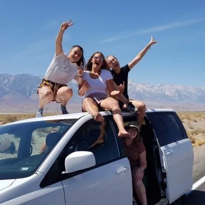 Girls sat on a car 