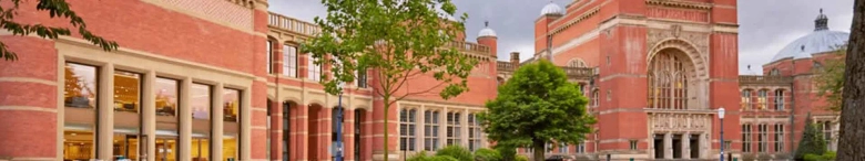 Panoramic view of the University of Birmingham campus showcasing the red brick architecture and greenery.