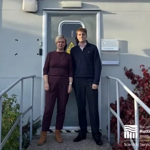 George and one female standing outside