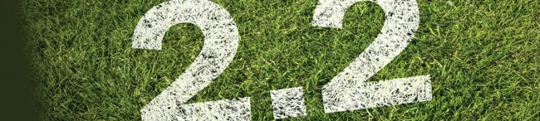 '2.2' painted in white on grass.