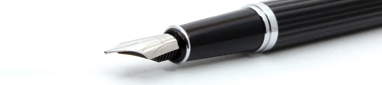 Close-up of a fountain pen on a white surface, symbolizing professional writing.