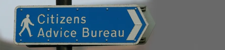 The image shows a sign pointing to the Citizens Advice Bureau, signifying pro bono legal experience