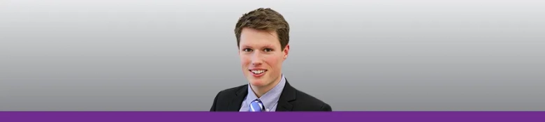 Confident young intern smiling in business attire against a grey background with a purple banner.
