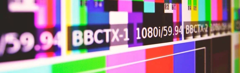 Close-up of a television calibration test card displaying various colors and resolution indicators.