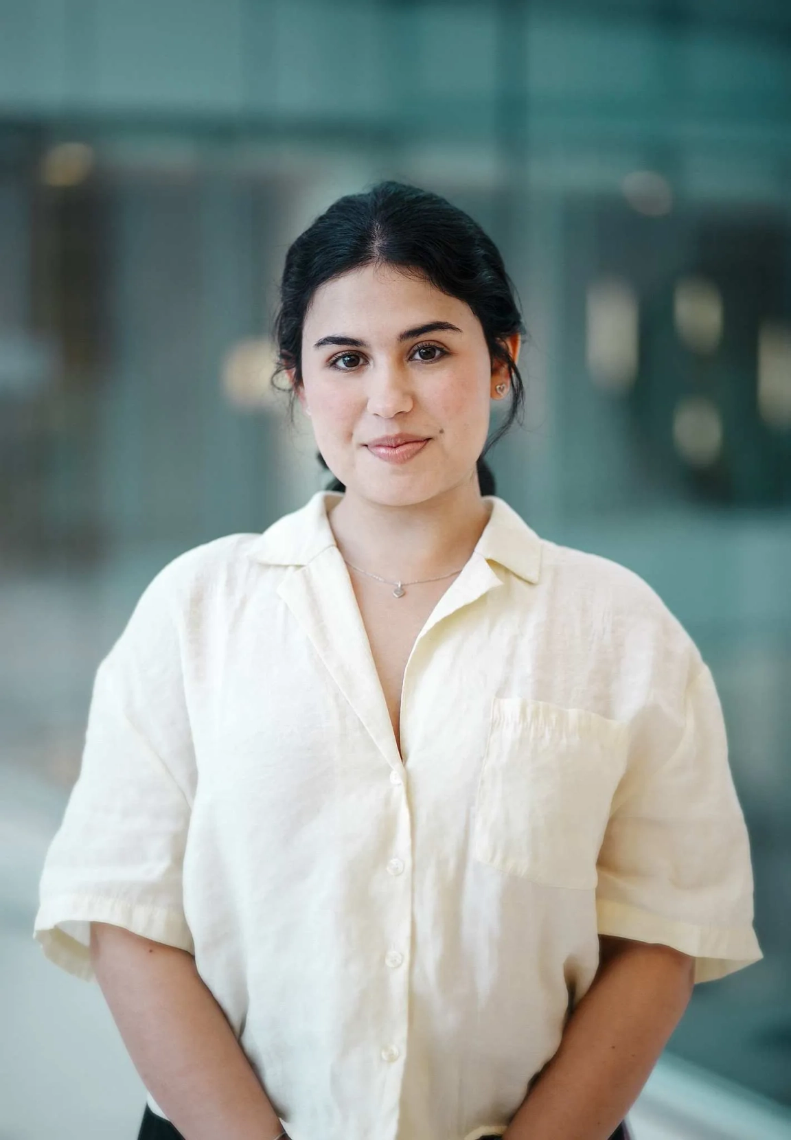 Female student with black hair wearing a white shirt