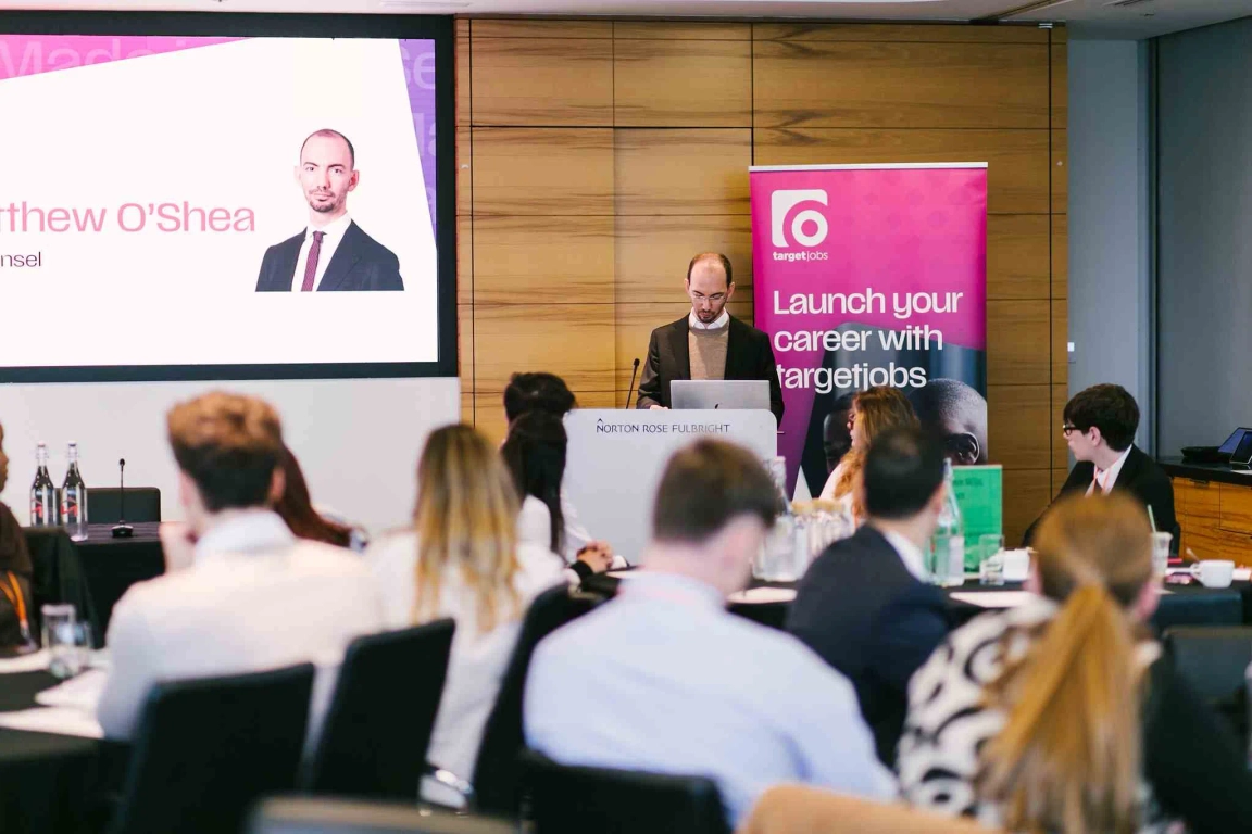 Keynote speech from Norton Rose Fulbright - male senior associate speaking into lectern