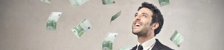 Man laughing with money falling from sky