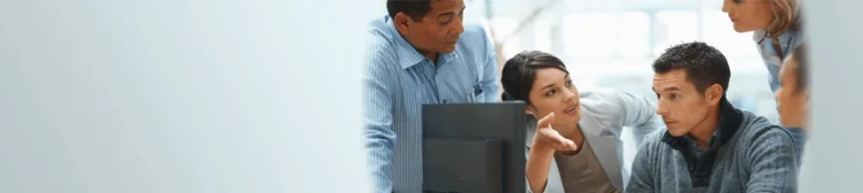 Employees gathered around a computer screen: skills for HR professionals
