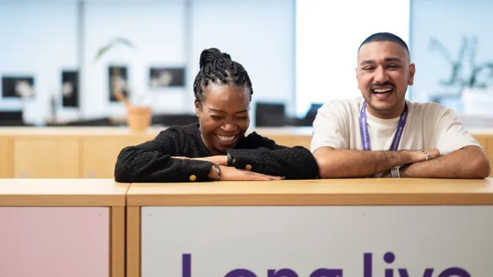 Two employees laughing