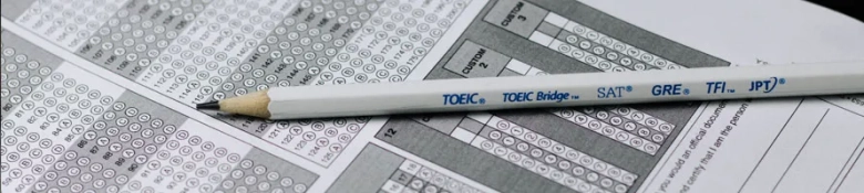 Multiple choice examination paper with pencil resting on top