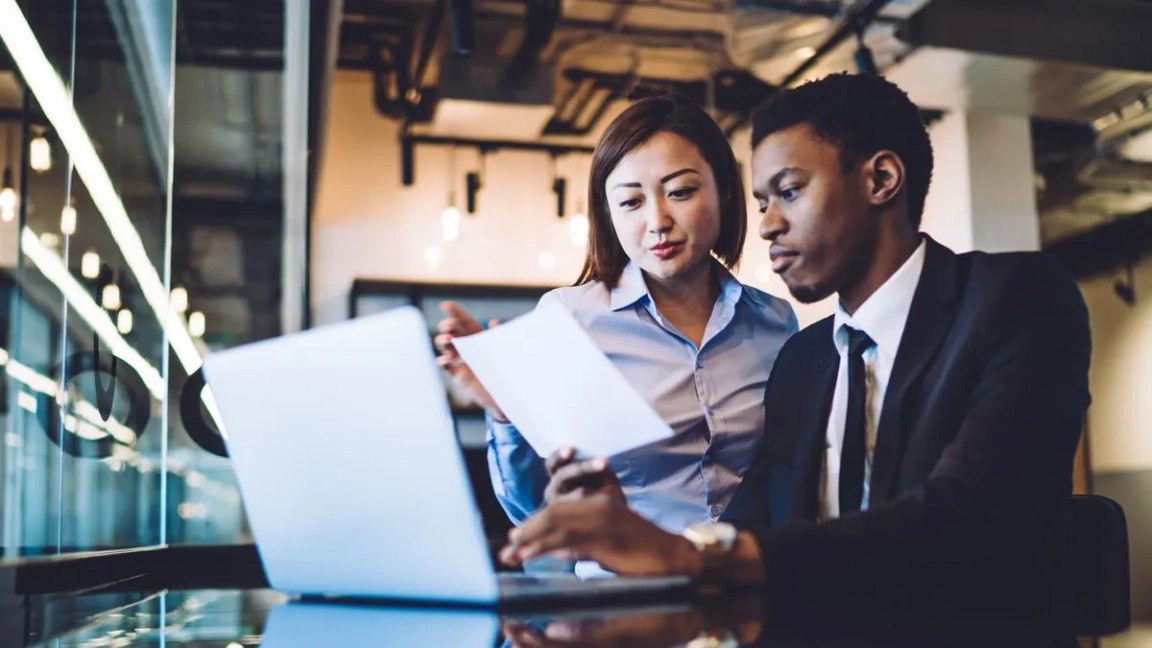 woman and man working on laptop together