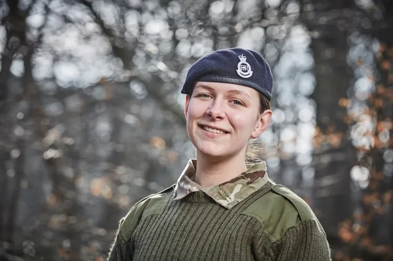 A member iof the army smiling at the camera