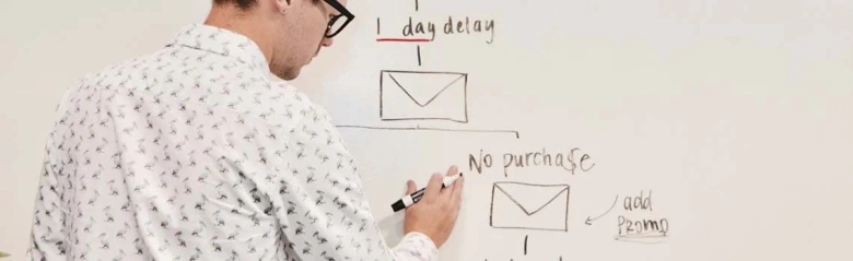 A training and development adviser writing notes on a whiteboard.