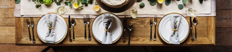 A dinner table with place settings for three people