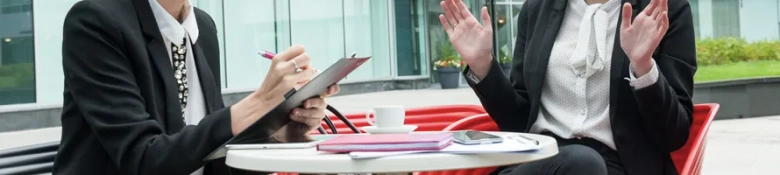 Two people in outdoor business meeting