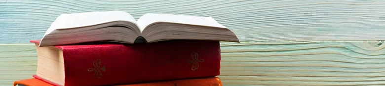 Book stack with a book open on top: literary agent job description