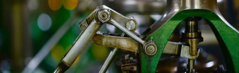 Close-up of a mechanical linkage system on industrial machinery.