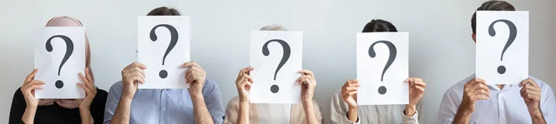 Five people holding question mark signs in front of their faces, symbolizing the search for an industrial placement.